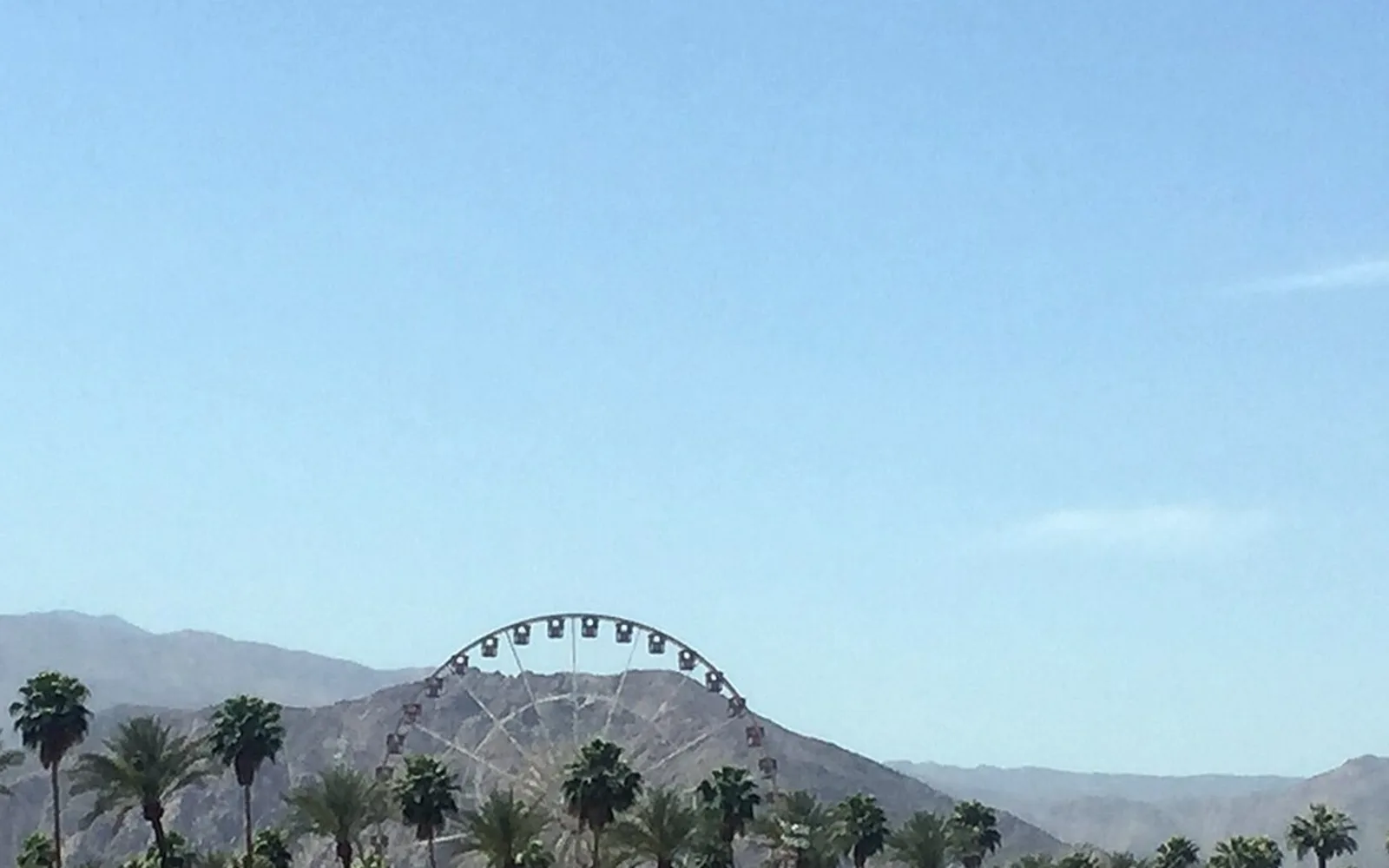 Ferris wheel and palms at the 2015 Coachella Valley Music and Arts Festival grounds; historical regional context.
