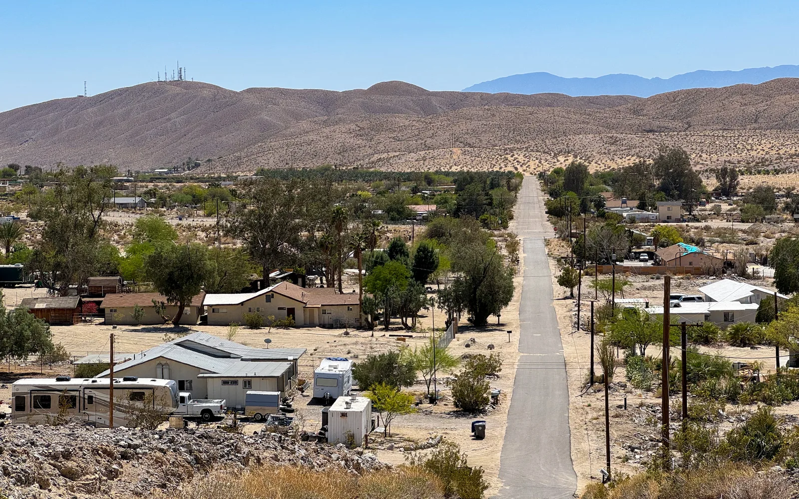 Desert landscape view of Indio Hills with the Santa Rosa Mountains visible in the distance under clear skies